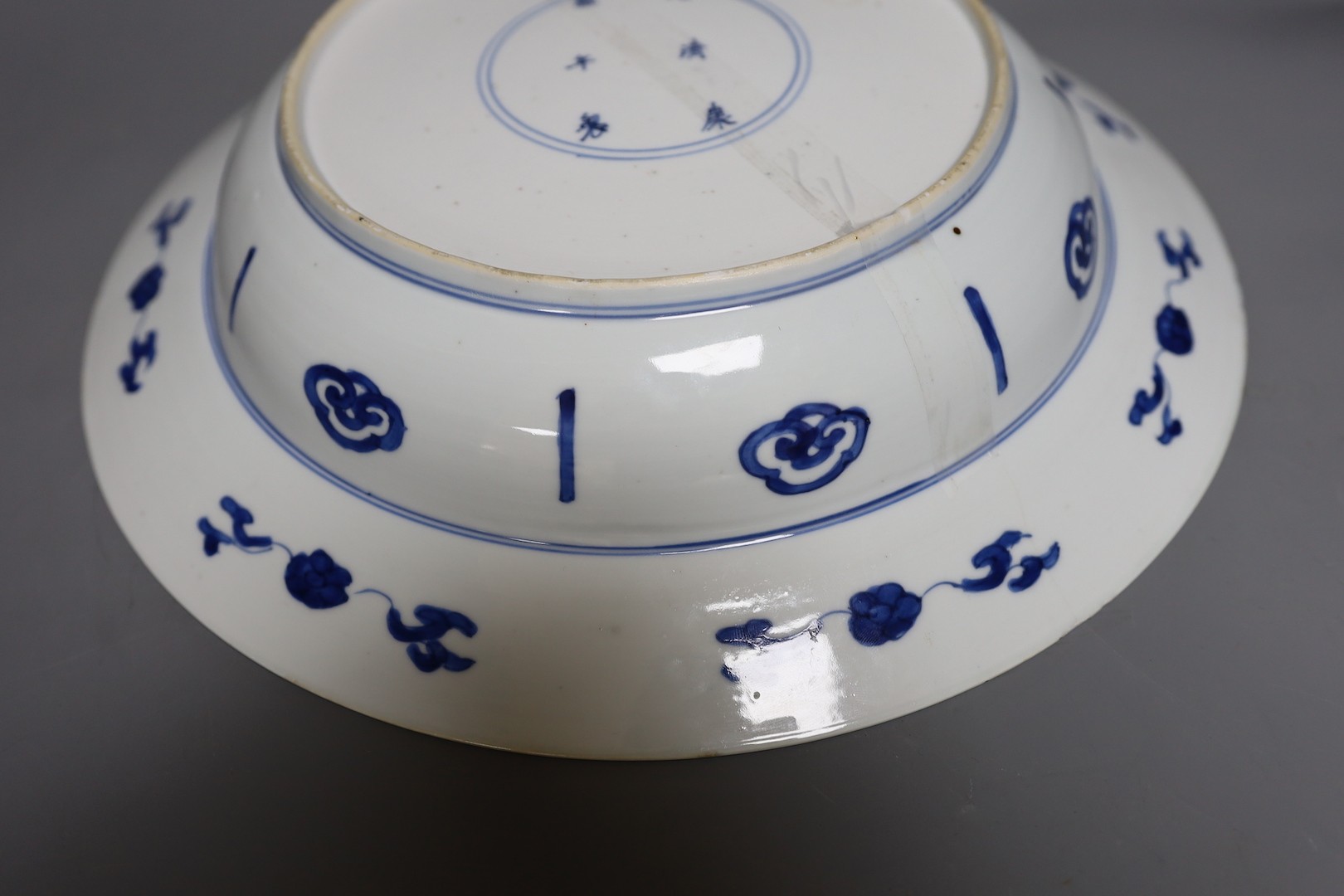 A Chinese blue and white ‘ladies’ basin, Kangxi period, cracked 34cm